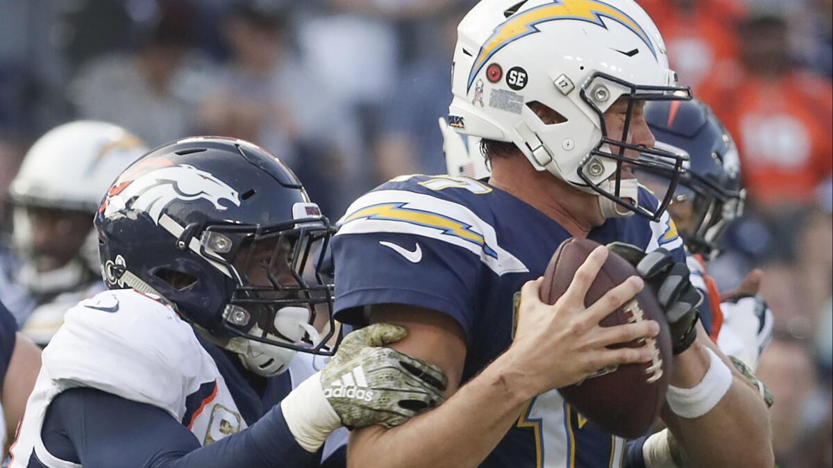 Broncos linebacker Von Miller sacks Chargers quarterback Philip Rivers during the second half Sunday at Stubhub Center.