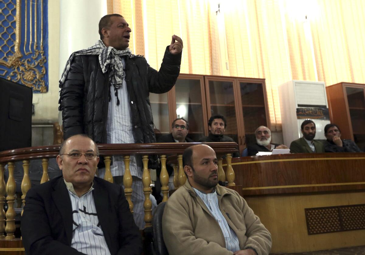 The former chief executive of Kabul Bank, Khalillulah Ferozi, speaks during an appeal hearing in Kabul on Nov. 10. The bank's former chairman, Sherkhan Farnood, is seated in the front on the left.
