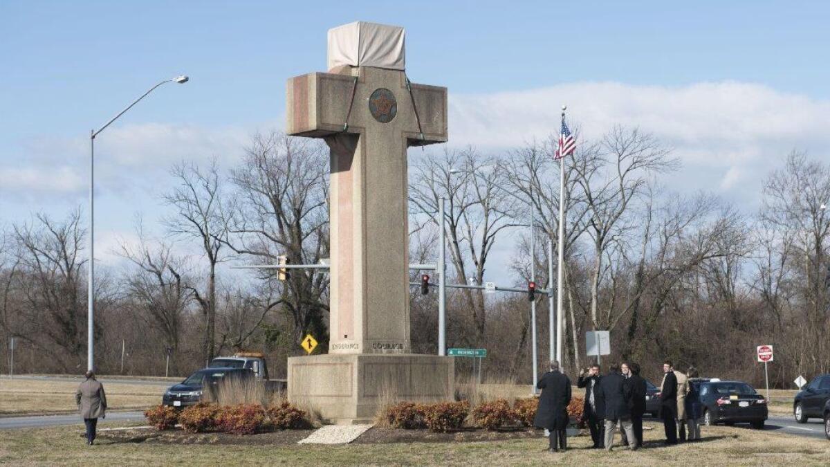 Visitors walk around the 40-foot Maryland Peace Cross, dedicated to World War I soldiers, in Bladensburg, Md.