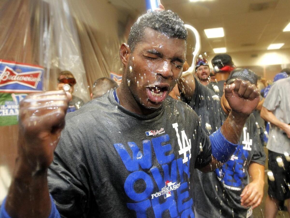 Yasiel Puig gets showered with champagne after the Dodgers clinched the NL West.