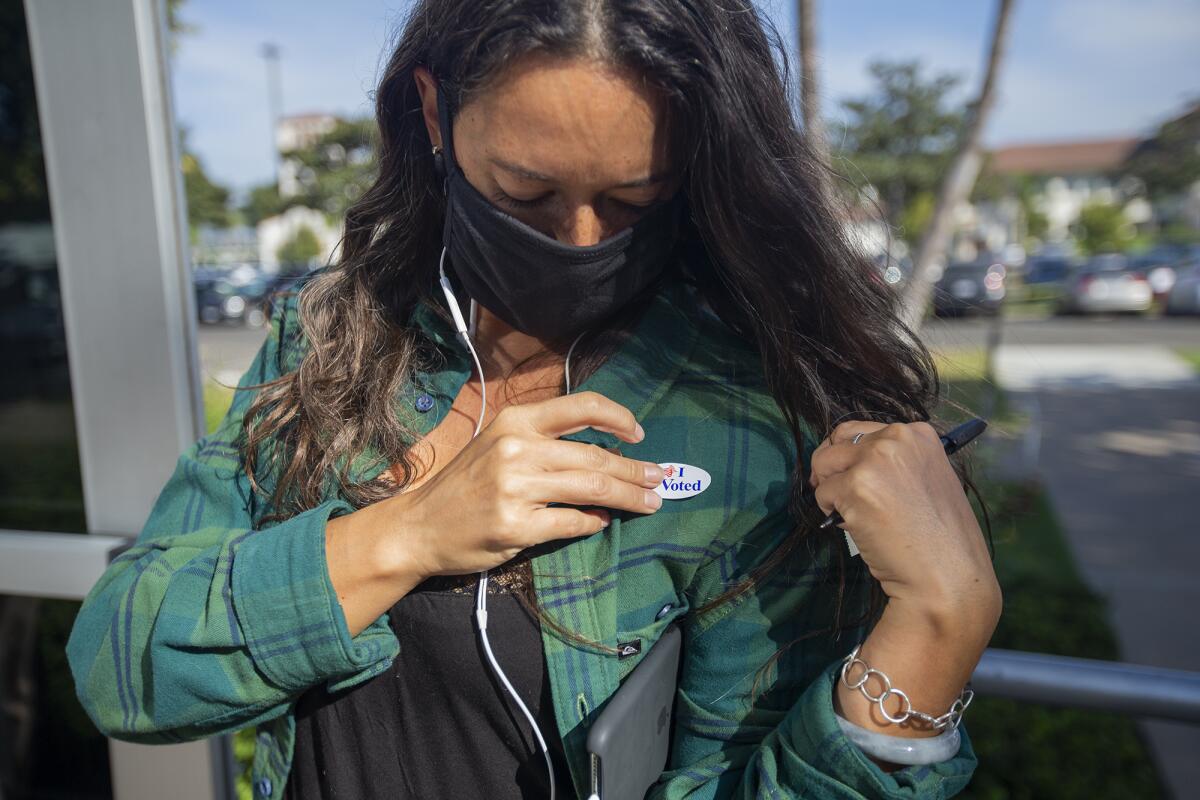 Jade Delmorris places an "I Voted" sticker on her jacket on Tuesday, November 3.