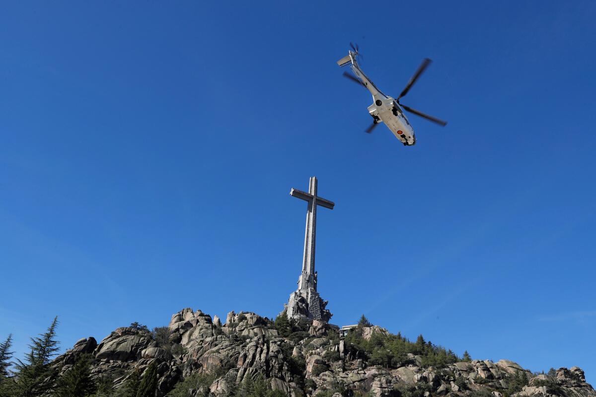 A Spanish army helicopter carrying the remains of dictator Francisco Franco leaves the Valle de los Caidos (Valley of the Fallen) mausoleum Oct. 24 in San Lorenzo del Escorial.