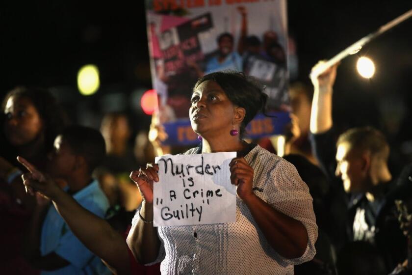 Supporters of Trayvon Martin wait in front of the Seminole County Criminal Justice Center last week for the verdict to be announced in the George Zimmerman murder trial in Sanford, Fla.