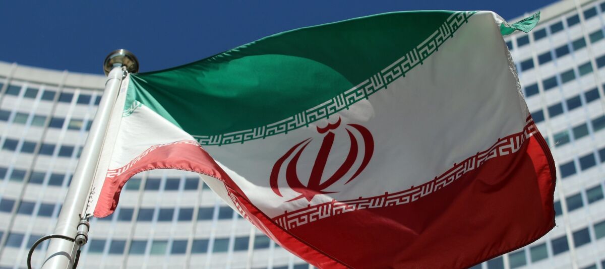 The Iranian flag flies in front of a UN building where closed-door nuclear talks take place at the International Center in Vienna, Austria, Friday, July 4, 2014. 