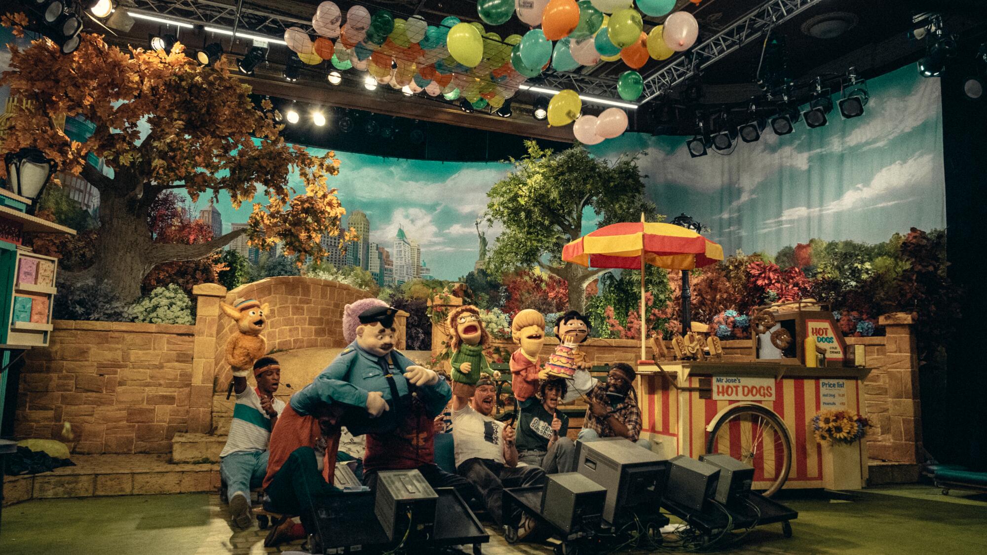 Puppets and puppeteers on the set of children's show.