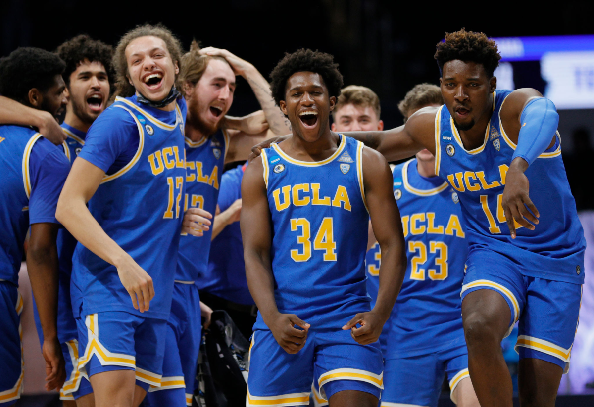 UCLA players, including David Singleton (34), Kenneth Nwuba (14) and Mac Etienne (12) celebrate.