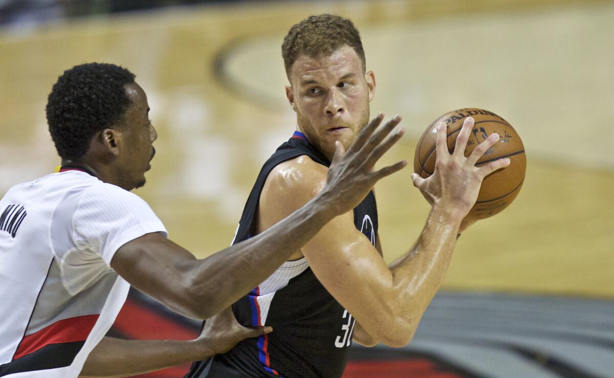 Clippers forward Blake Griffin, right, posts up against Portland Trail Blazers forward Al-Farouq Aminu during the first half of Game 3 of the Western Conference first round playoff on Apr. 23.