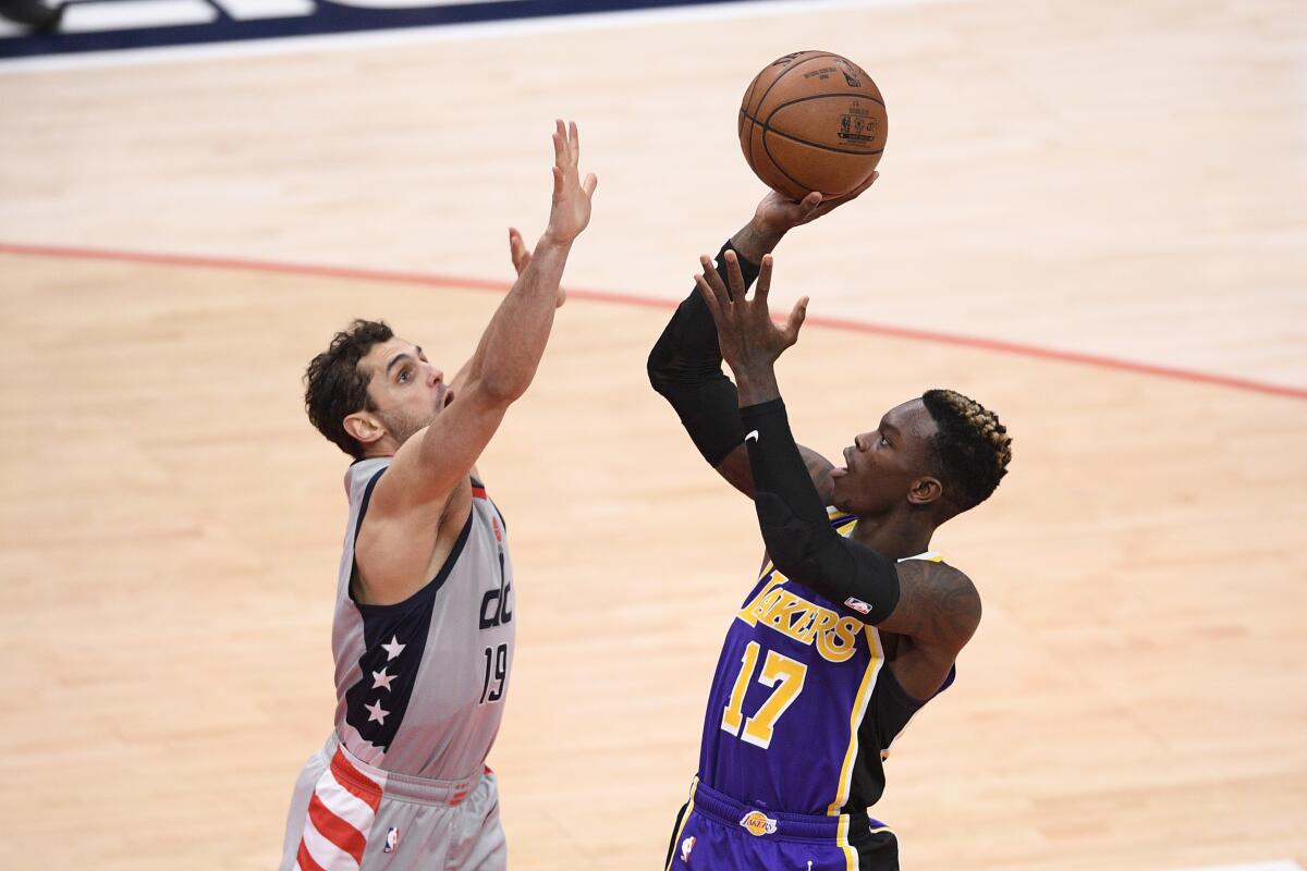 Lakers guard Dennis Schroder shoots against Washington Wizards guard Raul Neto.