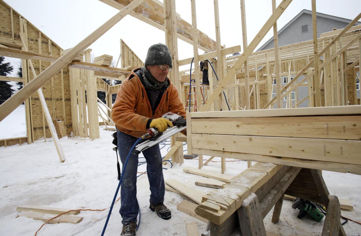 Carpenter Joe Tominc cuts wood for a post on a new home in Pepper Pike, Ohio, on Feb. 18.