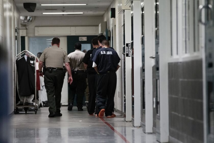 Sheriff's Deputies escorts inmates down a secured hallway at downtown Central Jail on Nov. 18, 2015, in San Diego. San Diego County jails have had more inmate deaths than comparable sized counties for the past 14 years and has consistently failed to address the problem, according to an independent review by the California's state auditor that recommended the state legislature intervene. (Nelvin C. Cepeda/The San Diego Union-Tribune via AP)