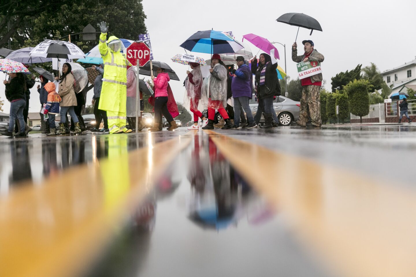Members of UTLA picket in heavy rain outside 99th Street Elementary School in South Los Angeles.