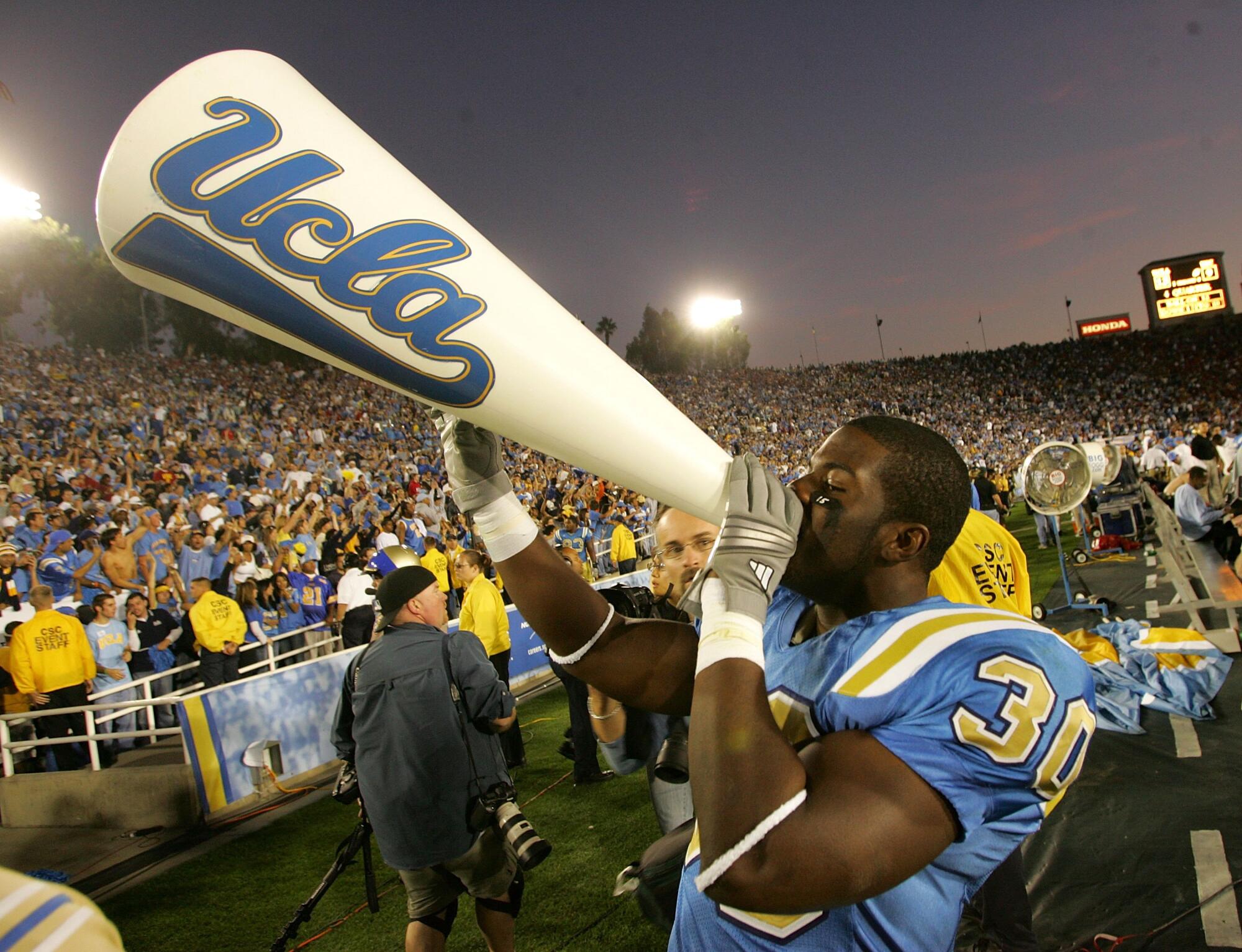 Commentary: Disgrace on UCLA for making an attempt to ditch the long-lasting Rose Bowl for money seize at SoFi Stadium 3 UCLA tailback Derrick Williams celebrates with a cheerleader's megaphone after defeating the USC at the Rose Bowl.