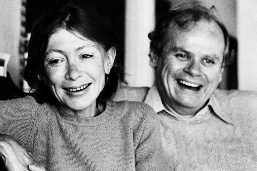 FILE - Authors Joan Didion, left, and her husband, John Dunne, appear in their Malibu home, Ca., in Dec. 1977. The archives of the late Joan Didion and John Gregory Dunne have been acquired by the New York Public Library. (AP Photo, File)
