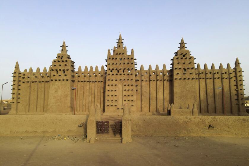 FILE- The world's largest mud-brick building, the Great Mosque of Djenne, Mali, awaits its annual replastering, Friday, May 10, 2024. The Mosque — the world's largest mud-brick building — used to draw tens of thousands of tourists every year to central Mali. Now it's threatened by conflict between Islamic rebels, government forces and other groups. (AP Photo/Moustapha Diallo, File)