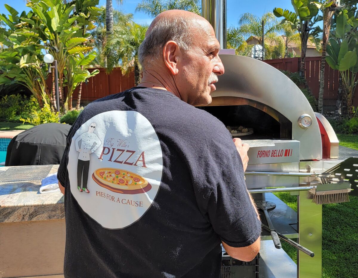 Willie DePascale of Chula Vista cooks pizzas in his backyard oven for charity.
