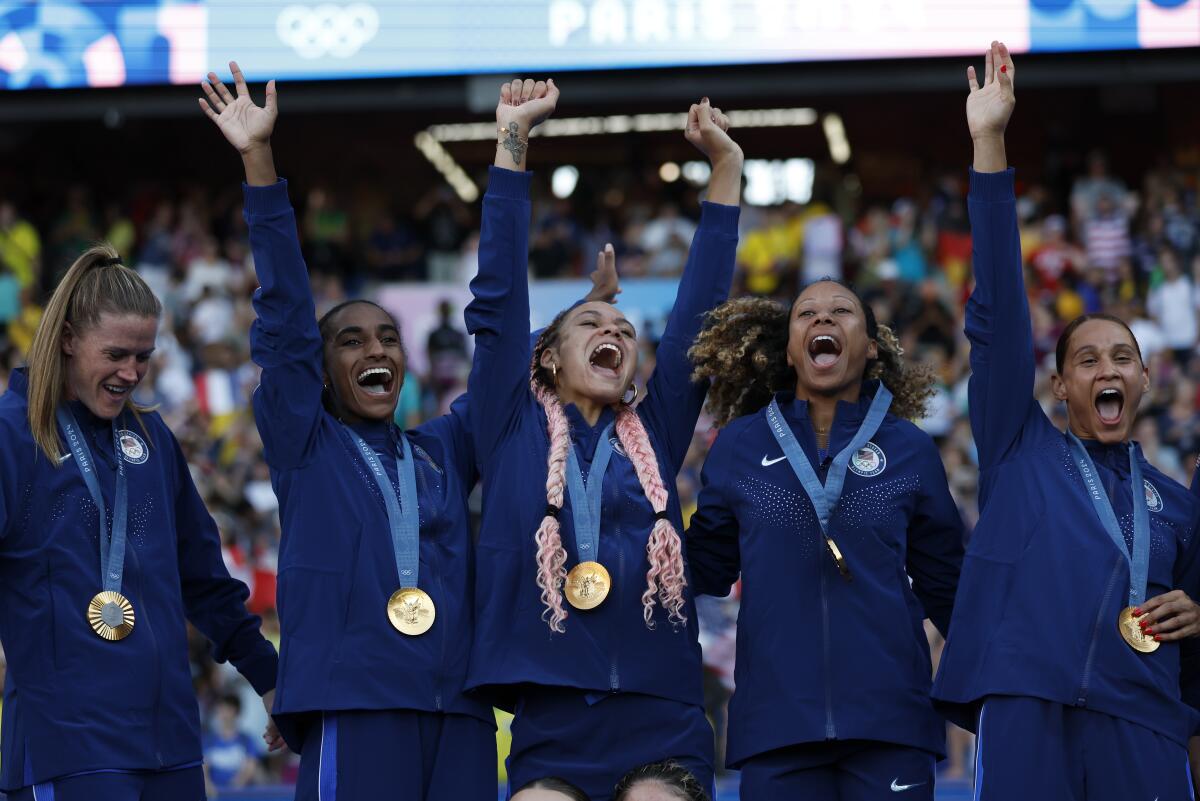 U.S. soccer players stand with their gold medals after beating Brazil at the Parc des Princes 