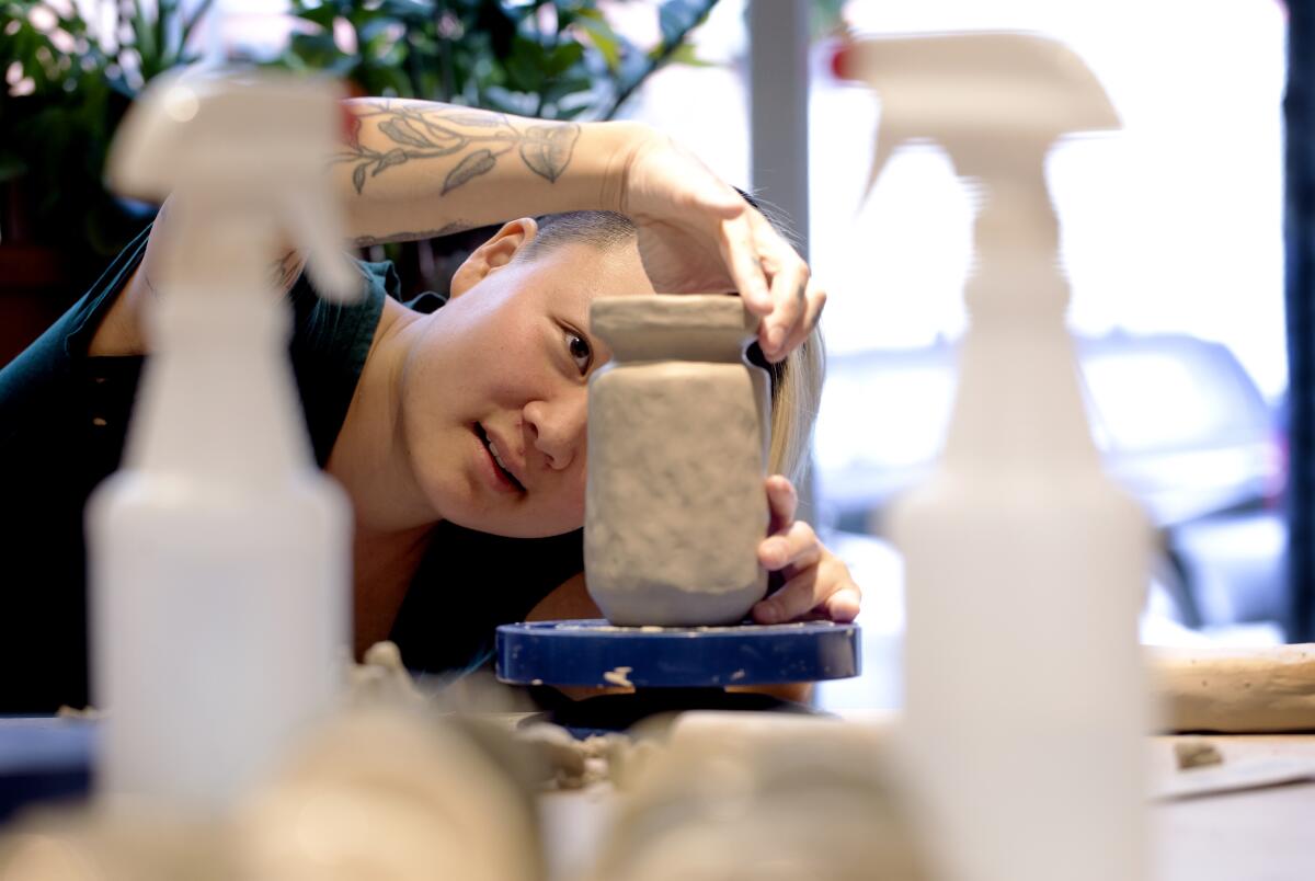 Artist Stephanie Shih works on a ceramic piece