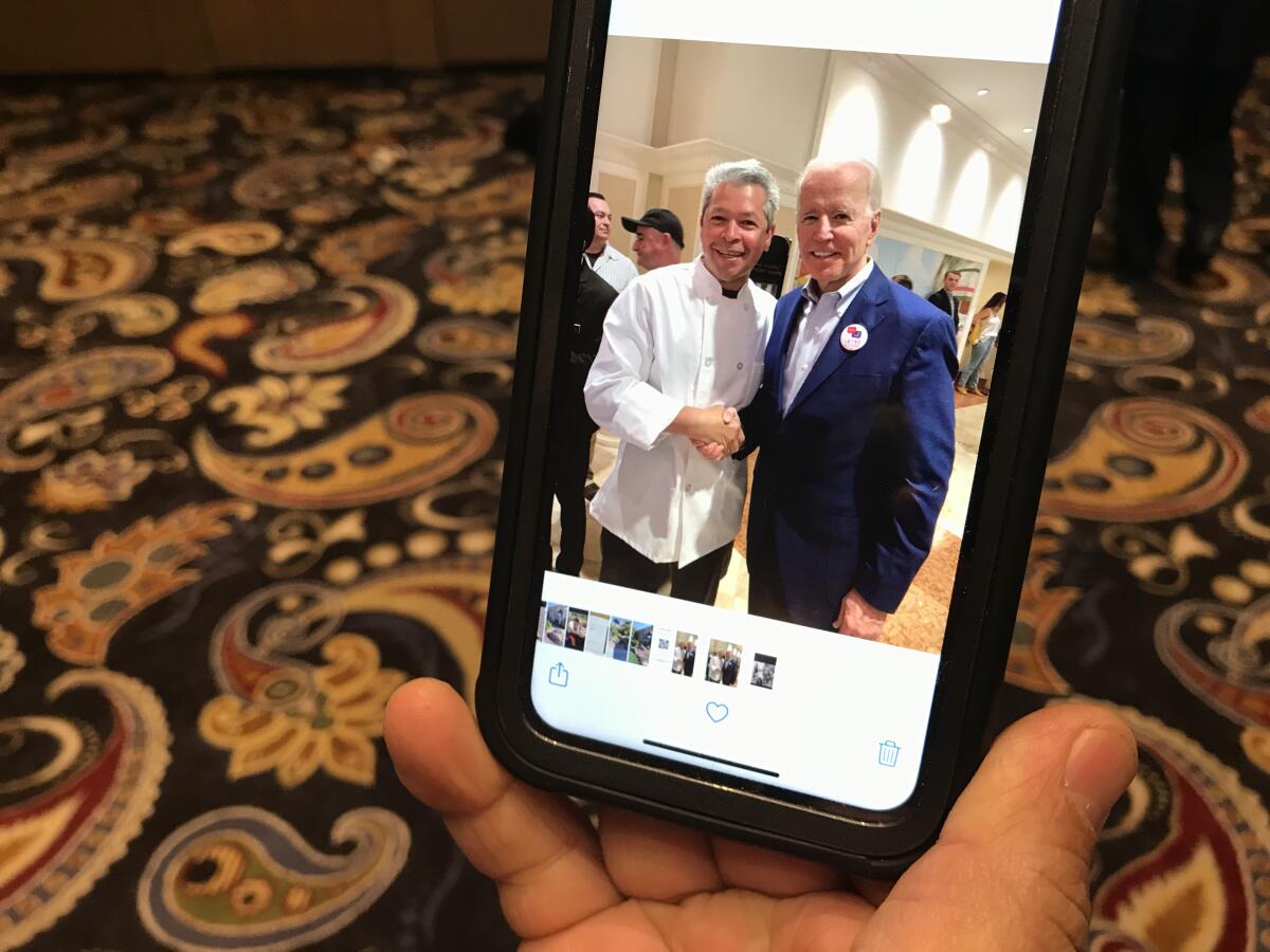 Walter Guardado, a cook at the Bellagio Hotel and Casino, shows a photo he took with presidential candidate Joe Biden.