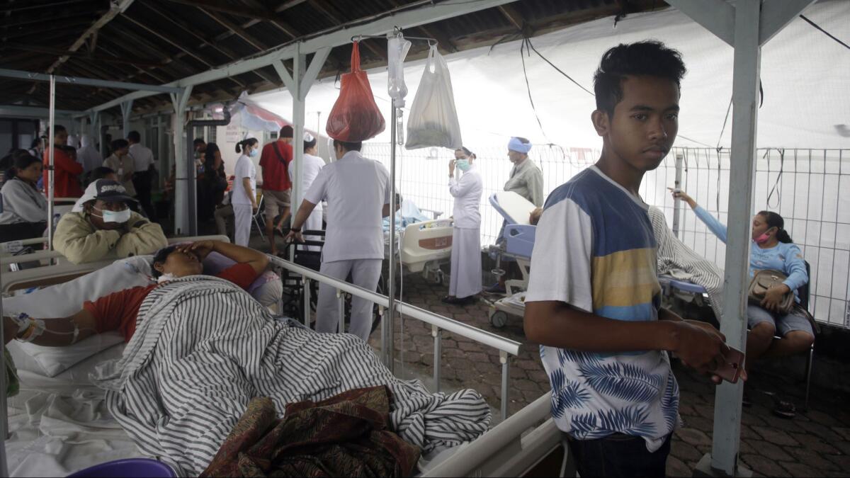 Patients are evacuated outside a hospital following an earthquake in Bali, Indonesia, on Monday.
