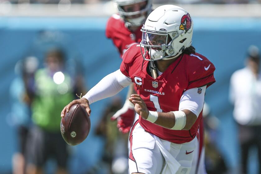 Arizona Cardinals quarterback Kyler Murray (1) looks for a receiver during the first half.