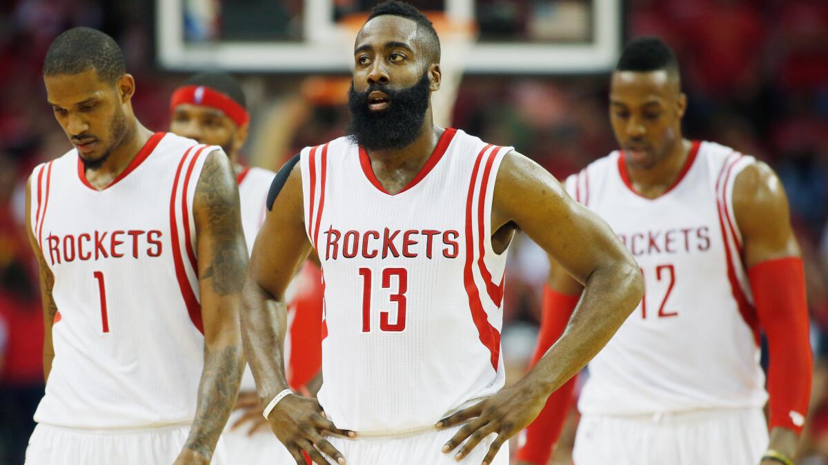 Houston Rockets teammates, from left, Trevor Ariza, James Harden and Dwight Howard walk to the bench during Game 1 of the Western Conference semifinals against the Clippers in Houston on May 4.