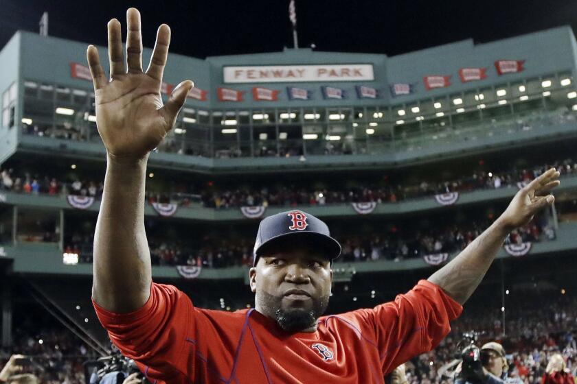 FILE - In this Oct. 10, 2016, file photo, Boston Red Sox's David Ortiz waves from the field at Fenway Park after Game 3 of baseball's American League Division Series against the Cleveland Indians in Boston. Officials say Ortiz, who was shot in the Dominican Republic on June 9, 2019, at an outdoor cafe, was the victim of incompetent criminals who were trying to kill a man next to him. (AP Photo/Charles Krupa, File)
