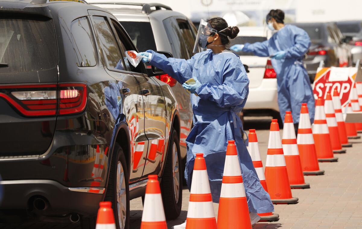 Drivers receive COVID-19 testing kits at the Charles R. Drew University of Medicine and Science in South L.A. on July 8.