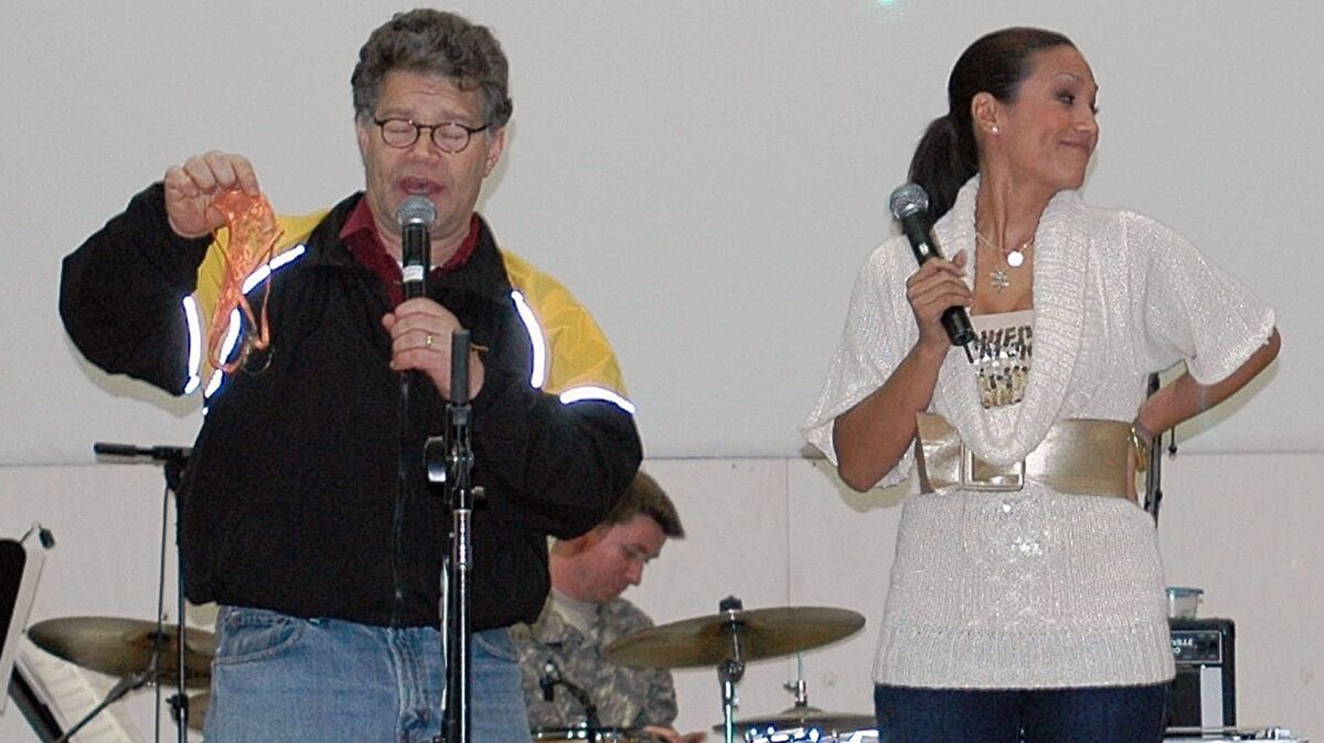 Then-comedian Al Franken and sports commentator Leeann Tweeden perform a comic skit in Mosul, Iraq, in 2006 as part of a USO tour.