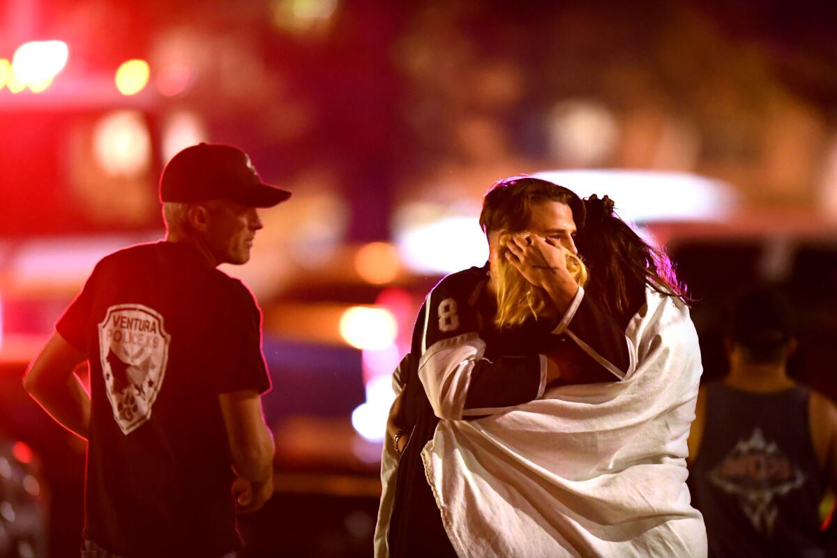 People comfort each other after the November 2018 mass shooting at the Borderline Bar and Grill in Thousand Oaks.