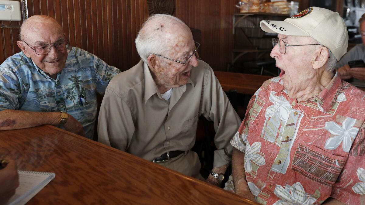 World War II veterans, from left, Darrell Lightner, Jack Geerlings and Earl Dahleen joke during a luncheon at American Legion Newport Harbor Post 291 celebrating the legion’s 99th anniversary.