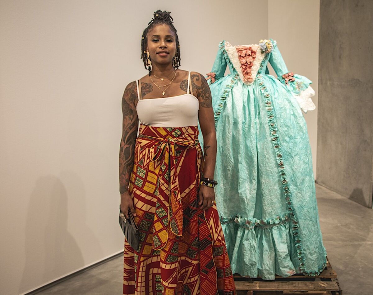 At the Sept. 6 opening of her Lux exhibition, Fabiola Jean-Louis posed with one of her paper gowns.
