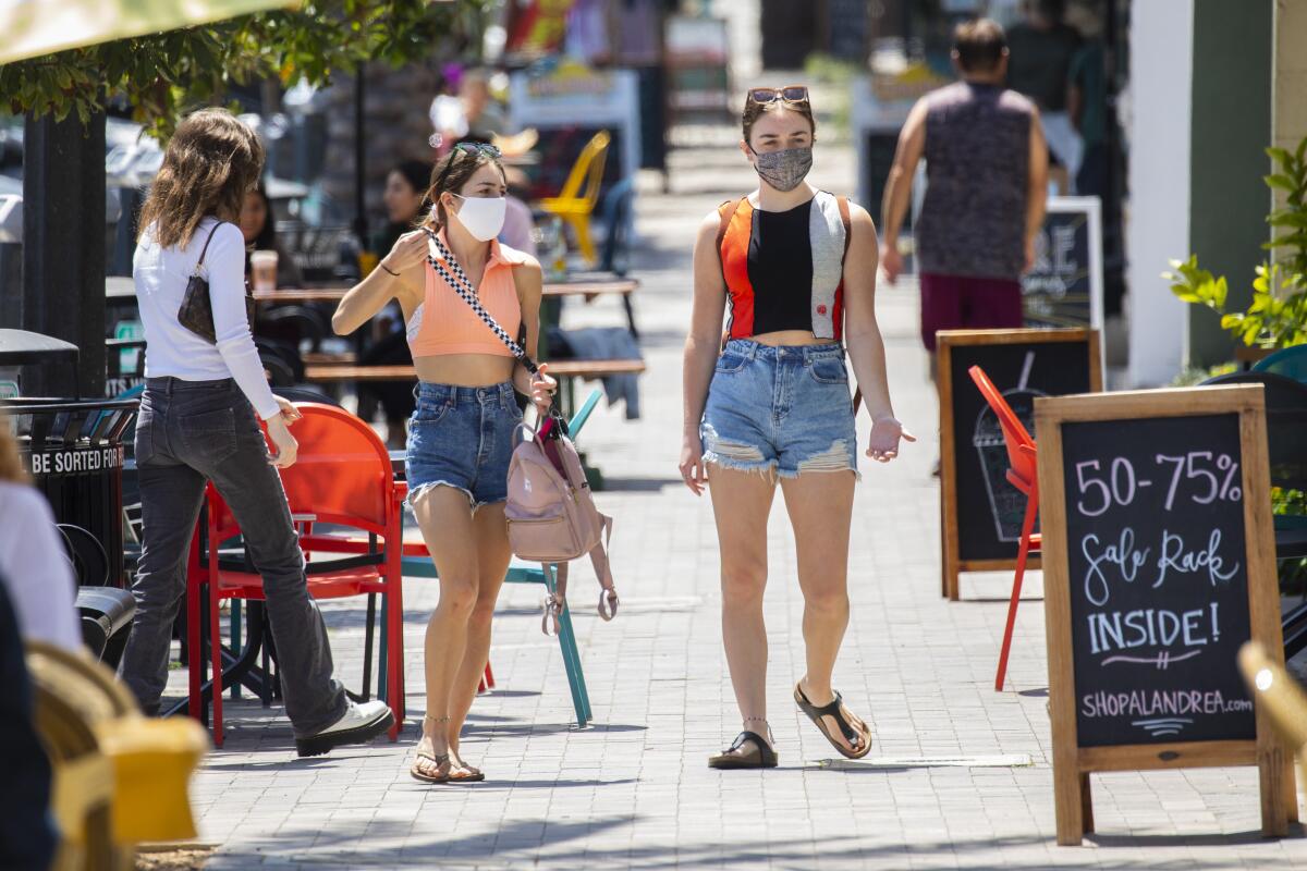 Two pedestrians wearing masks in Redondo Beach