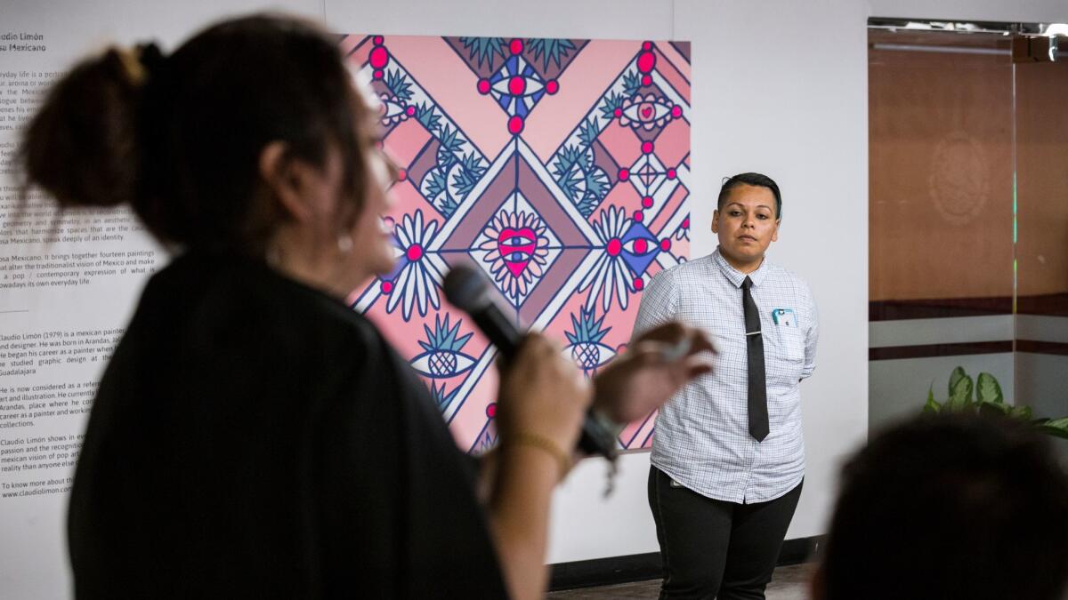 Dulce María Flores Colorado, right, who works in the legal department of the Mexican Consulate in Los Angeles, listens as Mariana Marroquin, program manager of the LGBT Center’s Anti-Violence Project, speaks at a sensitivity training session.
