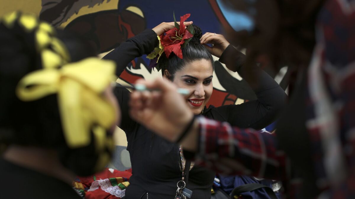 Angela Vera, 21, of Ballet Folklórico de UCI, gets ready to perform on the campus of UC Irvine.