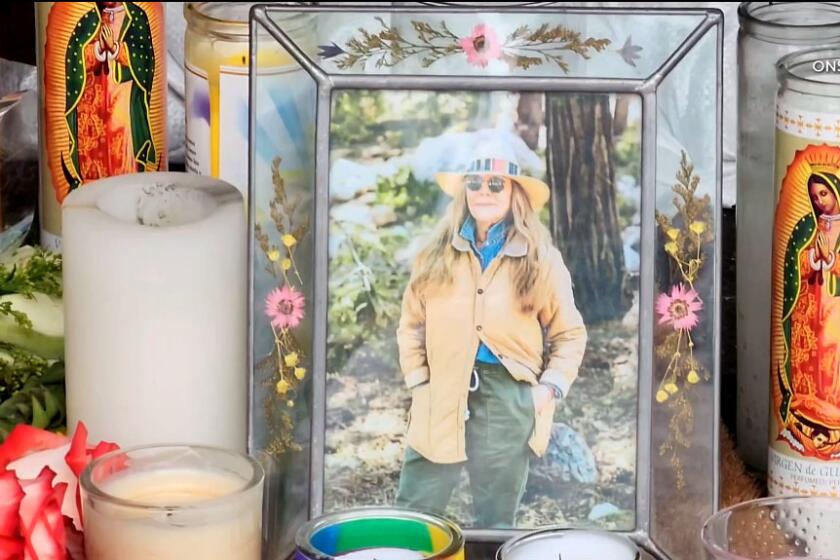 A photo of Mag.pi owner Laura Ann Carleton is placed among the candles outside the store on Aug. 19, 2023 in Cedar Glen. (ONSCENE.TV)