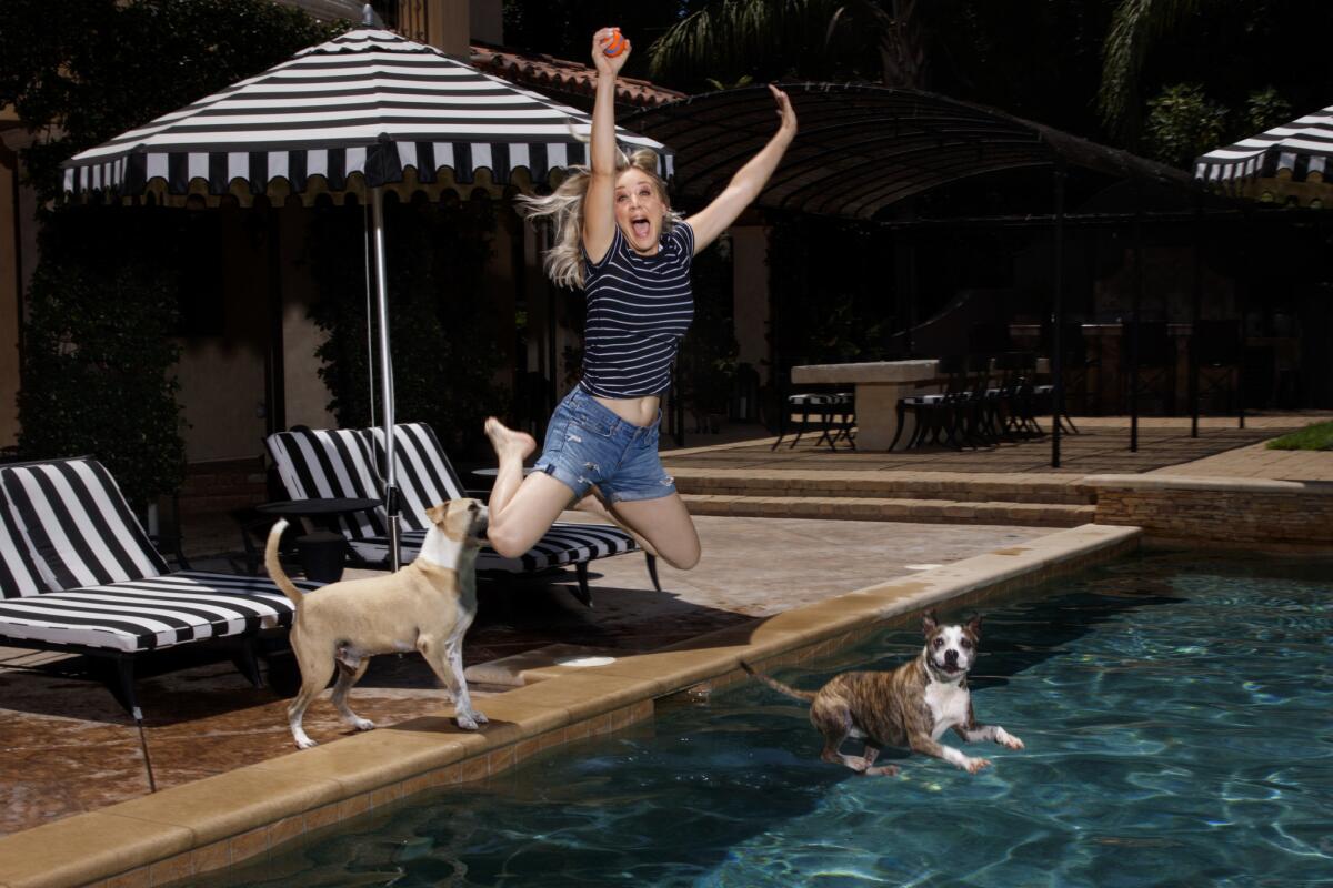 Actress Kaley Cuoco jumps into her pool with Shirley, in air, and Norman, who stopped at the edge, on Aug. 7.