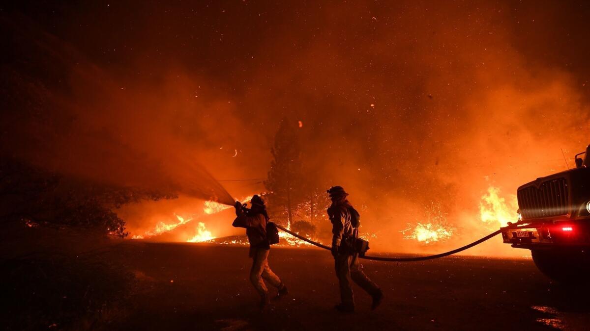 Firefighters continued to battle wildfires throughout California on Tuesday. Here, Cal Fire crews fight the Delta fire as it burned north of Redding on Friday.