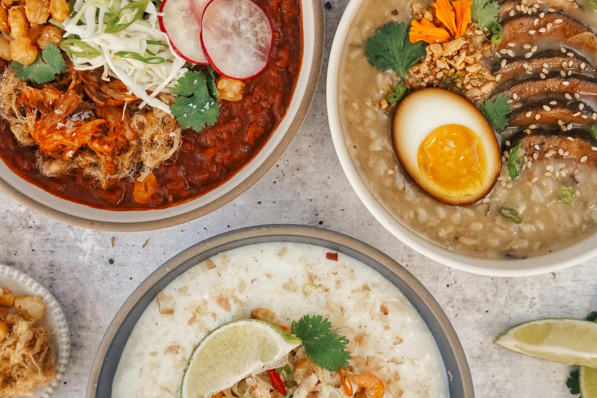 Overhead view of three porridge-like dishes