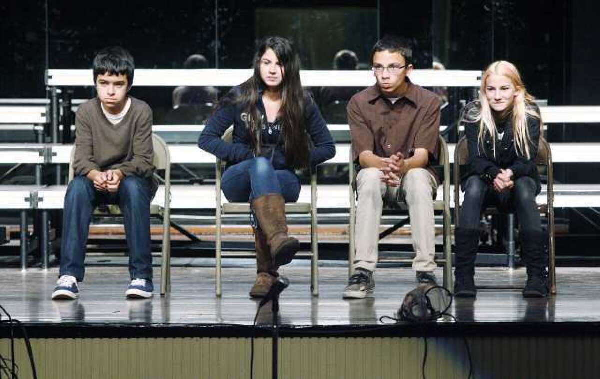 Students Justin Palomino, Giana Riad, Dominic Perez and Emma Wochner, who wrote the scene "The Runaway," answer questions from the audience after their scene was performed by professional actors at Luther Burbank Middle School in Burbank.