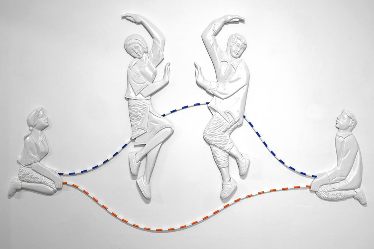 Sculpture of people jumping rope.