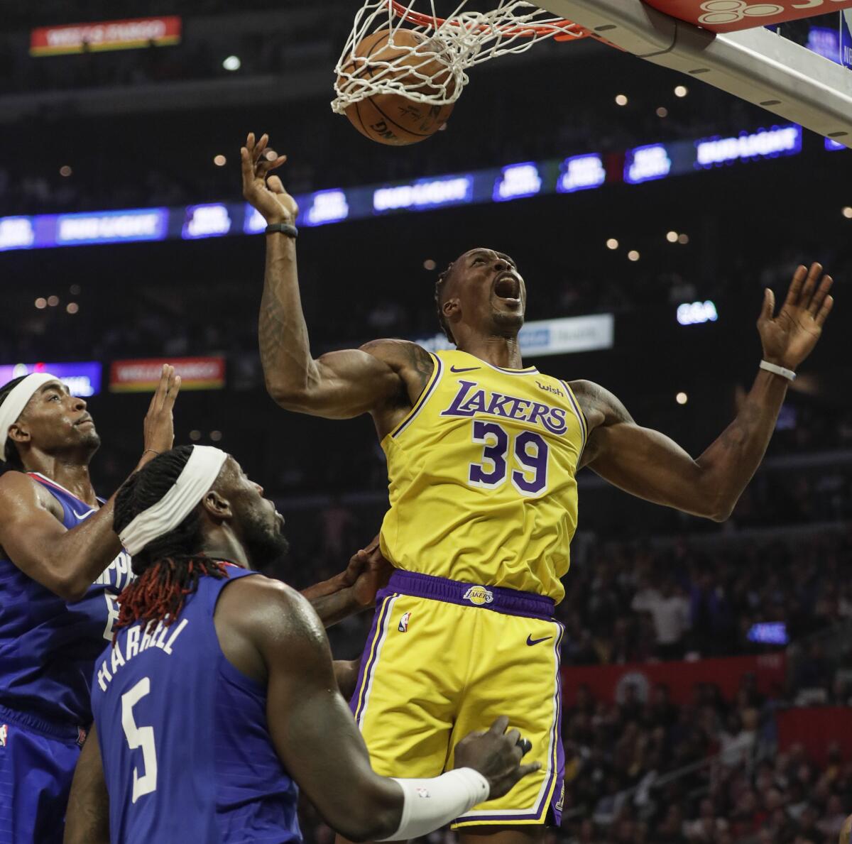 Los Angeles Lakers' Dwight Howard (39) dunk against Los Angeles Clippers' Montrezl Harrell (5).