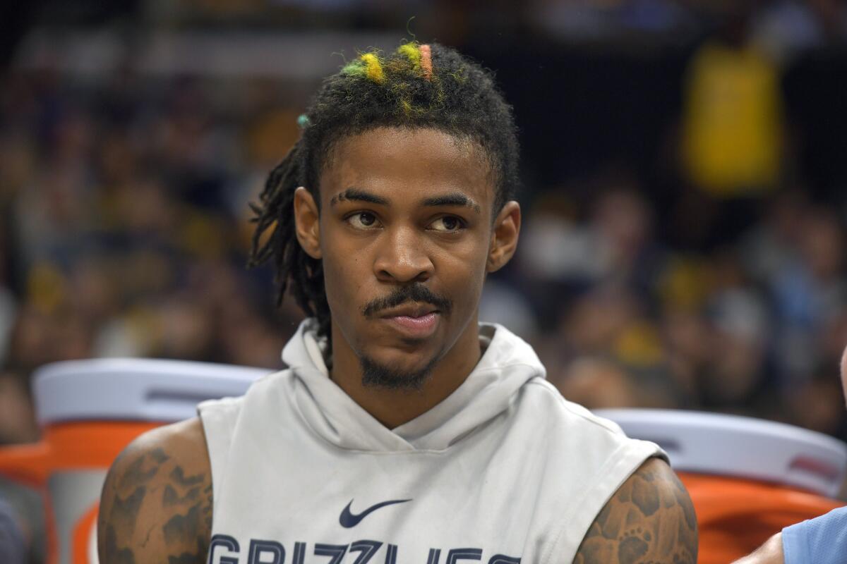 Grizzlies guard Ja Morant sits on the bench during a game last sesaon.