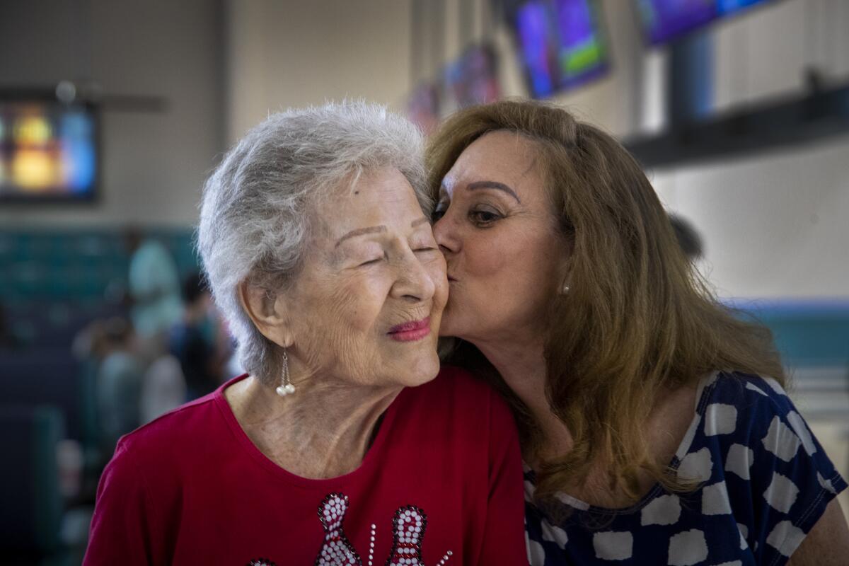 Lillian Solomon gets a kiss from her daughter, Rayanne Weiss.