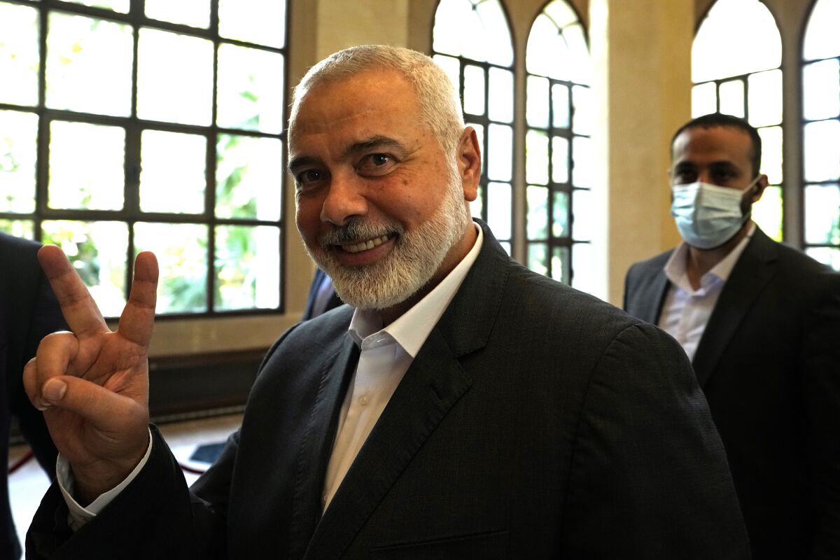 FILE - In this June 28, 2021 file photo, Ismail Haniyeh, the leader of the Palestinian militant group Hamas, flashes the victory sign after his meeting with Lebanese Parliament Speaker Nabih Berri, in Beirut, Lebanon. Hamas on Sunday, Aug. 1, 2021, said it has re-elected Haniyeh as its supreme leader. Haniyeh, who has been living in exile for the past two years, was given a new four-year term by the Shura Council, the Islamic group's top decision-making body. He was unopposed. (AP Photo/Hassan Ammar, File)