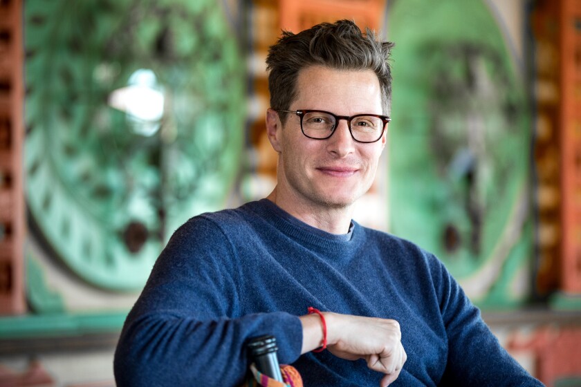 Bandcamp CEO Ethan Diamond in a blue sweatshirt and glasses