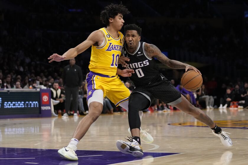Los Angeles Lakers guard Max Christie (10) defends against Sacramento Kings guard Malik Monk.