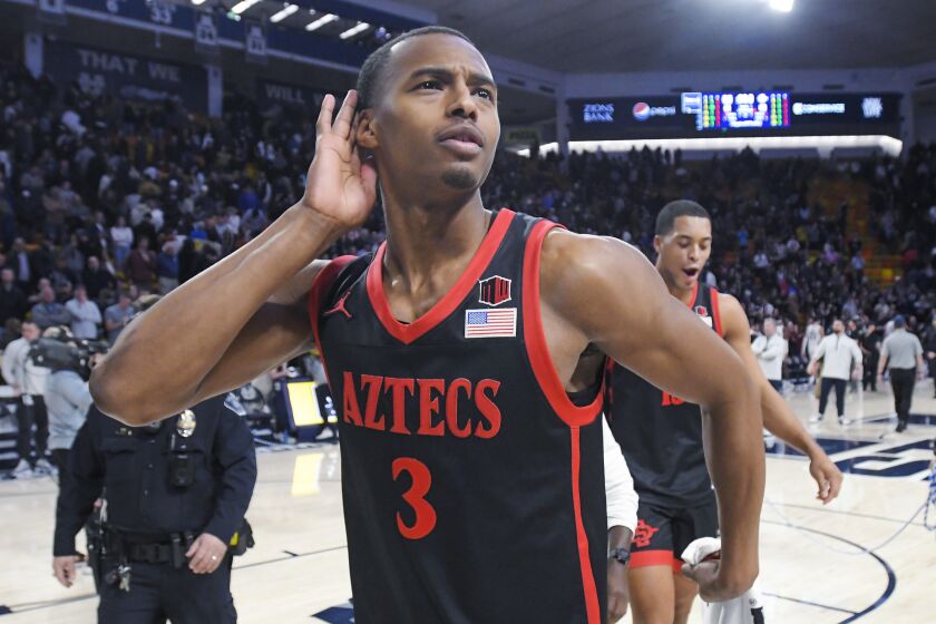 San Diego State guard Micah Parrish gestures to the crowd after the team's win over Utah State in an NCAA college basketball game Wednesday, Feb. 8, 2023, in Logan, Utah. (AP Photo/Eli Lucero)