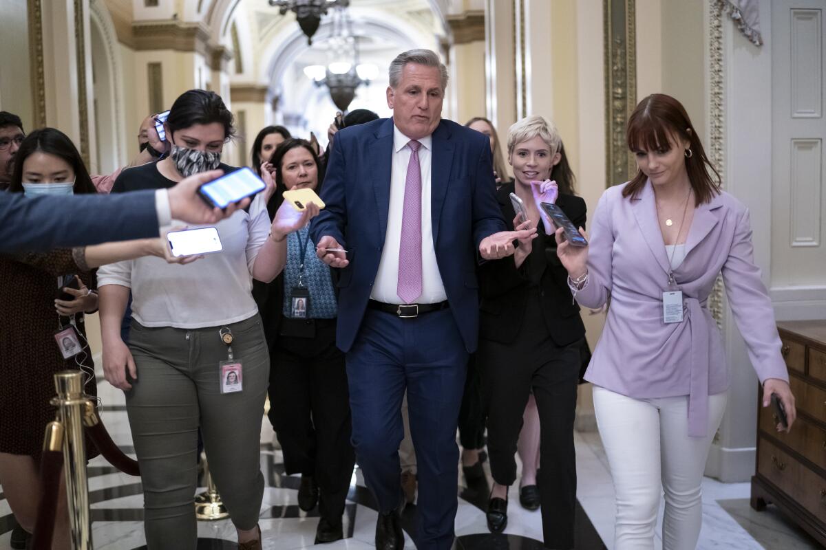 Kevin McCarthy speaking to a group of reporters as he walks