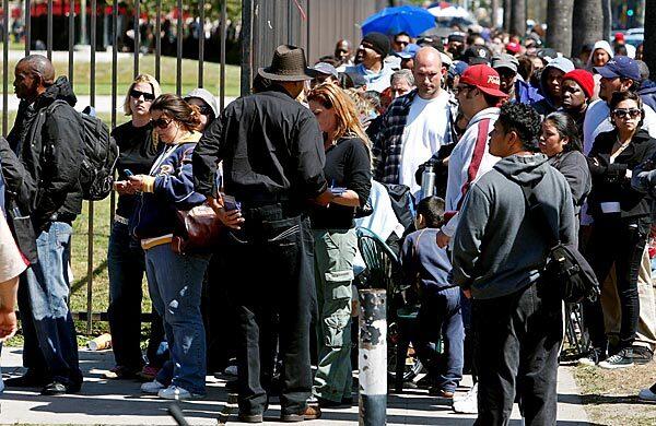 Thousands of people line the perimeter of the L.A. Sports Arena hoping to get wristbands for access to free medical care from Remote Area Medical's seven-day clinic. Only 1,200 wristbands were handed out Wednesday, leaving many disappointed and frustrated. Read complete free clinic coverage.