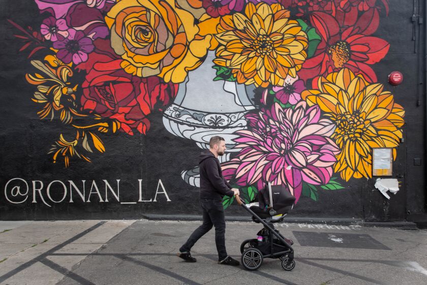 LOS ANGELES, March 16, 2020: Daniel Cutler walks with his daughter McKenna into his restaurant Ronan on March 16, 2020, the day after Eric Garcetti announced that all restaurants in Los Angeles must close due to the Coronavirus. (Allison Zaucha / For The Times)